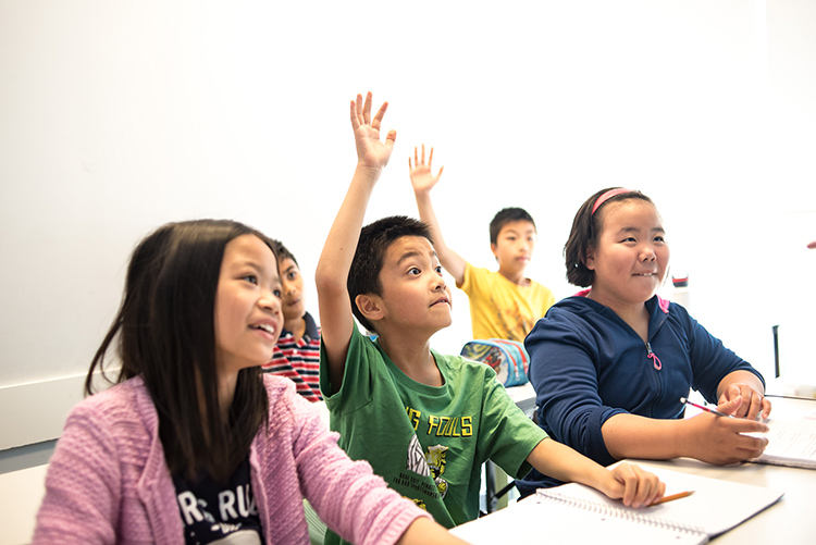 children raising their hands